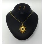 An antique garnet and seed pearl set pendant in yellow metal pendant on a fine chain also a pair