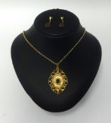 An antique garnet and seed pearl set pendant in yellow metal pendant on a fine chain also a pair