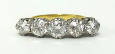 A fine 18ct gold five stone diamond ring with platinum claw settings, set with five graduating old