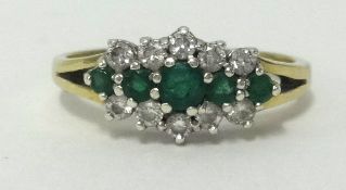 A 9ct emerald cluster, finger size P