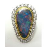 A large opal and diamond cluster ring, approx 34mm long by 22mm wide, set in 18ct yellow gold,