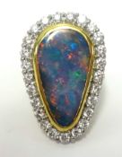 A large opal and diamond cluster ring, approx 34mm long by 22mm wide, set in 18ct yellow gold,