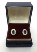 A pair of cluster earrings, diamond effect, set in white metal.
