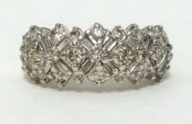 A 14ct diamond set band ring with an arrangement of baguette and round cut diamonds, finger size M.