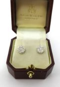 A pair of 18ct white and yellow gold diamond cluster earrings, stud style, hallmarked Edinburgh,