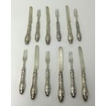 A Victorian twelve setting of dessert eaters and knifes and forks with silver blades.