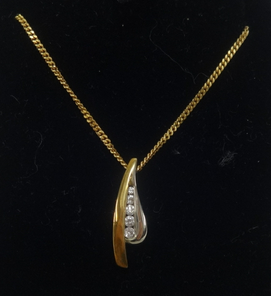 A 9ct white and yellow gold pendant set with a row of five graduating round diamonds, on fine gold