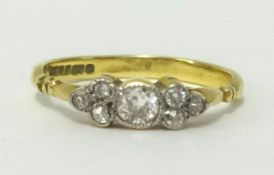 A 18ct gold diamond dress ring set with an arrangement of seven old cut diamonds, ring size J/K.