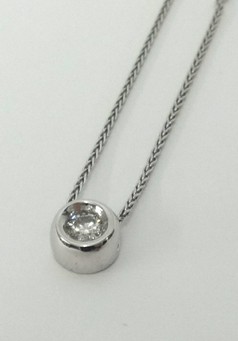 A modern 9ct white gold pendant set with round cut diamond on fine chain.