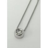 A modern 9ct white gold pendant set with round cut diamond on fine chain.