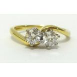 An 18ct diamond crossover ring set with two stones, finger size O.