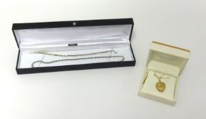 A 9ct gold locket necklace on fine gold chain together with two silver and gilt bracelets.