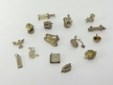 A collection of fifteen various silver charms.