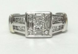 A 14k white gold and diamond set square cluster ring, set with an arrangement of baguette princess