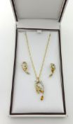A citrine and diamond set pendant and matching earrings en suite, set in 9ct gold with fine gold