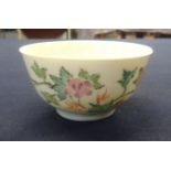 A Chinese porcelain tea bowl decorated with ducks and bright flowers, diameter 7cm.