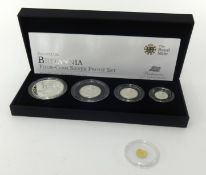 A Gold 2010 Cook Islands 1/2 of a dollar also the Royal Mint cased set Britannia 4 coin silver proof