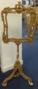 A 19th Century gilt tripod fire screen, height 119cm.