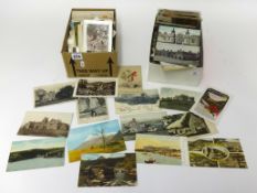 Four boxes of various Edwardian and later postcards.