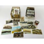 Four boxes of various Edwardian and later postcards.