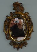 A pair of gilt framed antique wall mirrors.