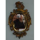 A pair of gilt framed antique wall mirrors.