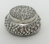 A Chinese silver pill box, stamped with Chinese character marks, approx 50mm diameter.