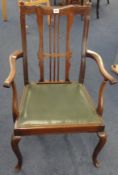 A traditional mahogany framed open elbow chair.