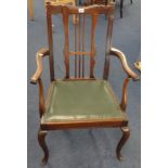 A traditional mahogany framed open elbow chair.