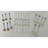 Four sets of tea spoons, including two sets of Geo V silver spoons and two sets of novelty silver