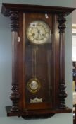 A eight day wall clock in mahogany case with split turned column mouldings.