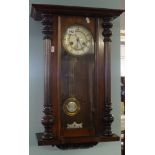A eight day wall clock in mahogany case with split turned column mouldings.