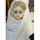 An early 20th Century German composition doll, blue fixed eyes, closed mouth (with under dress