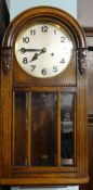 Early 20th Century oak wall clock with eight day movement.