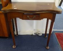 A mahogany fold over table, of 18th century design, with green baize, single drawer, turned legs