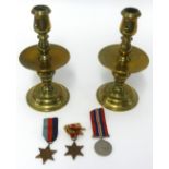 A pair of 19th Century brass candlesticks and drip trays, height 23cm and a group of three WWII