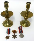 A pair of 19th Century brass candlesticks and drip trays, height 23cm and a group of three WWII