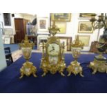 A reproduction French three piece clock garniture set, decorated in gilt metal work and porcelain,