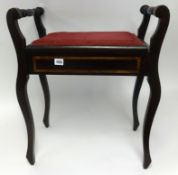 An early 20th Century stained wood and inlaid piano stool.