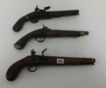 Three antique flintlock pistols.