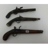 Three antique flintlock pistols.