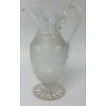 A Victorian glass and etched water jug, height 30cm.