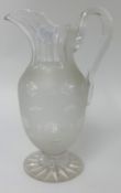 A Victorian glass and etched water jug, height 30cm.