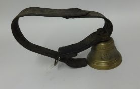 An antique Swiss cow bell on leather strap.