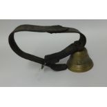 An antique Swiss cow bell on leather strap.