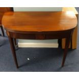 A 19th Century mahogany D end fold over tea table on square inlaid tapered legs, width 92cm.