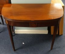 A 19th Century mahogany D end fold over tea table on square inlaid tapered legs, width 92cm.