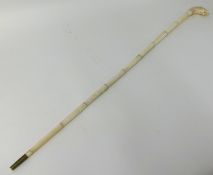 An antique carved ivory walking cane, the knop in the form of a lion, 92cm