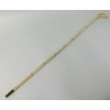 An antique carved ivory walking cane, the knop in the form of a lion, 92cm