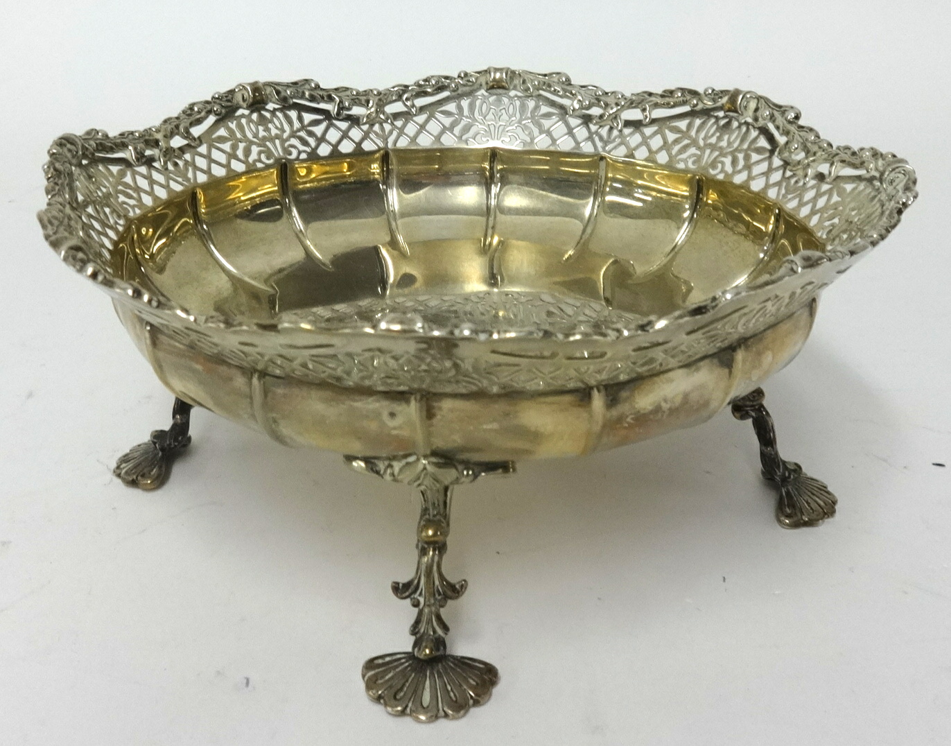 A George V silver and pierced dish on four legs with fan feet, approx 14.56oz, diameter 19cm.